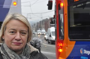 Natalie Bennett in front of a passing bus